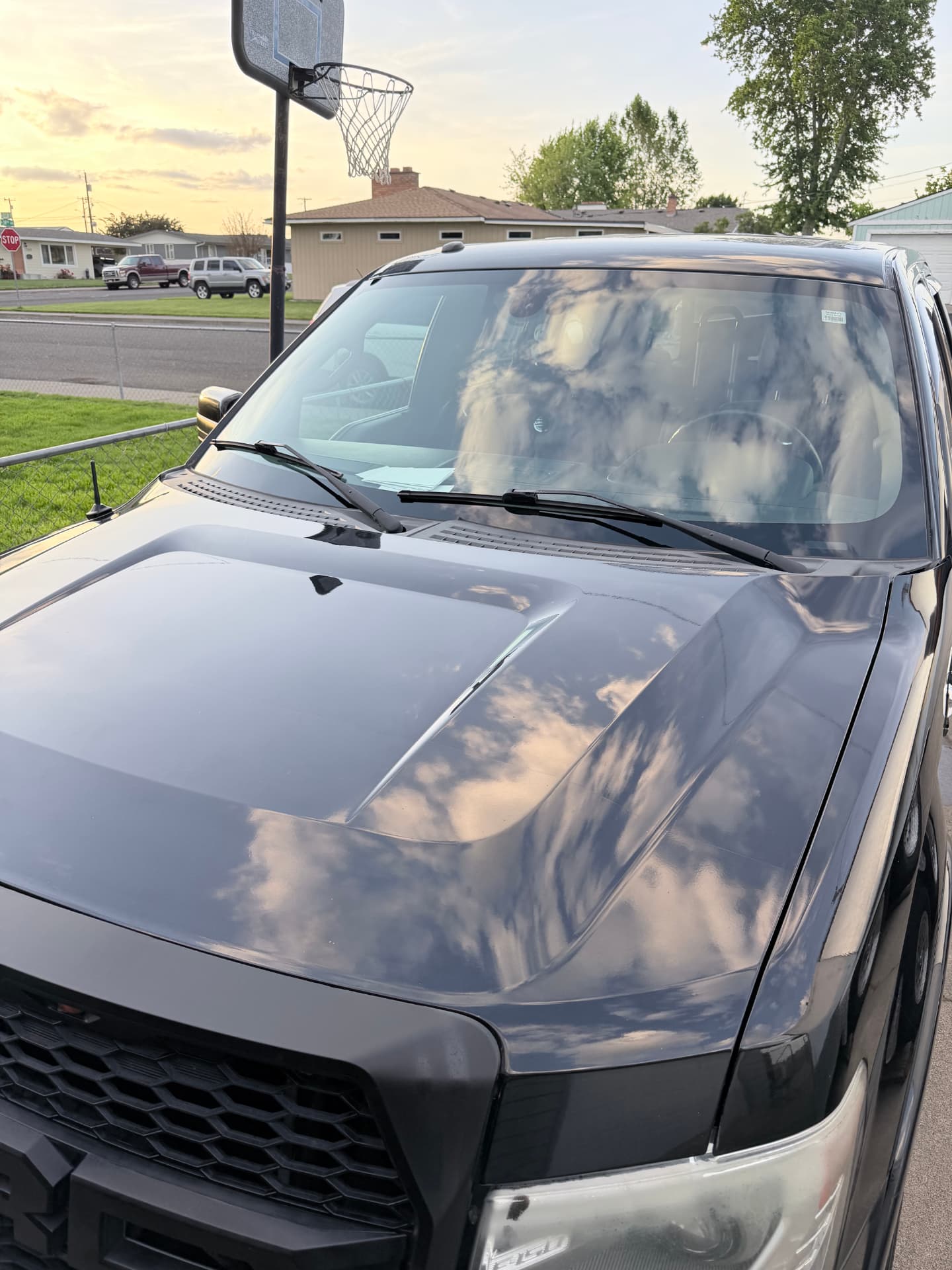 Close-up of reflections in a ceramic coated black truck hood